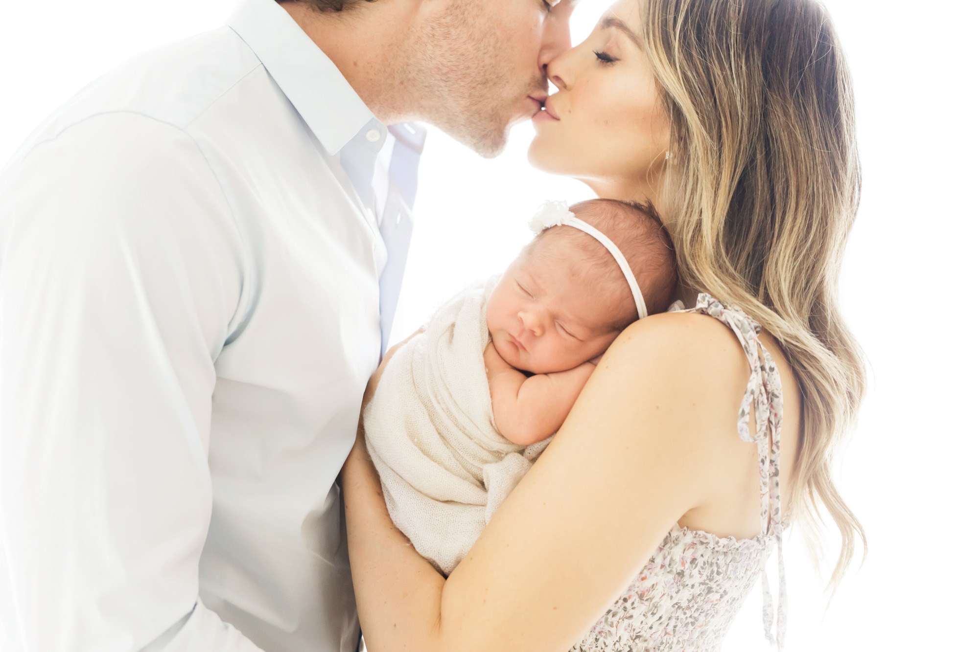 Two parents holding their newborn, photographed by Fresh Light Photography