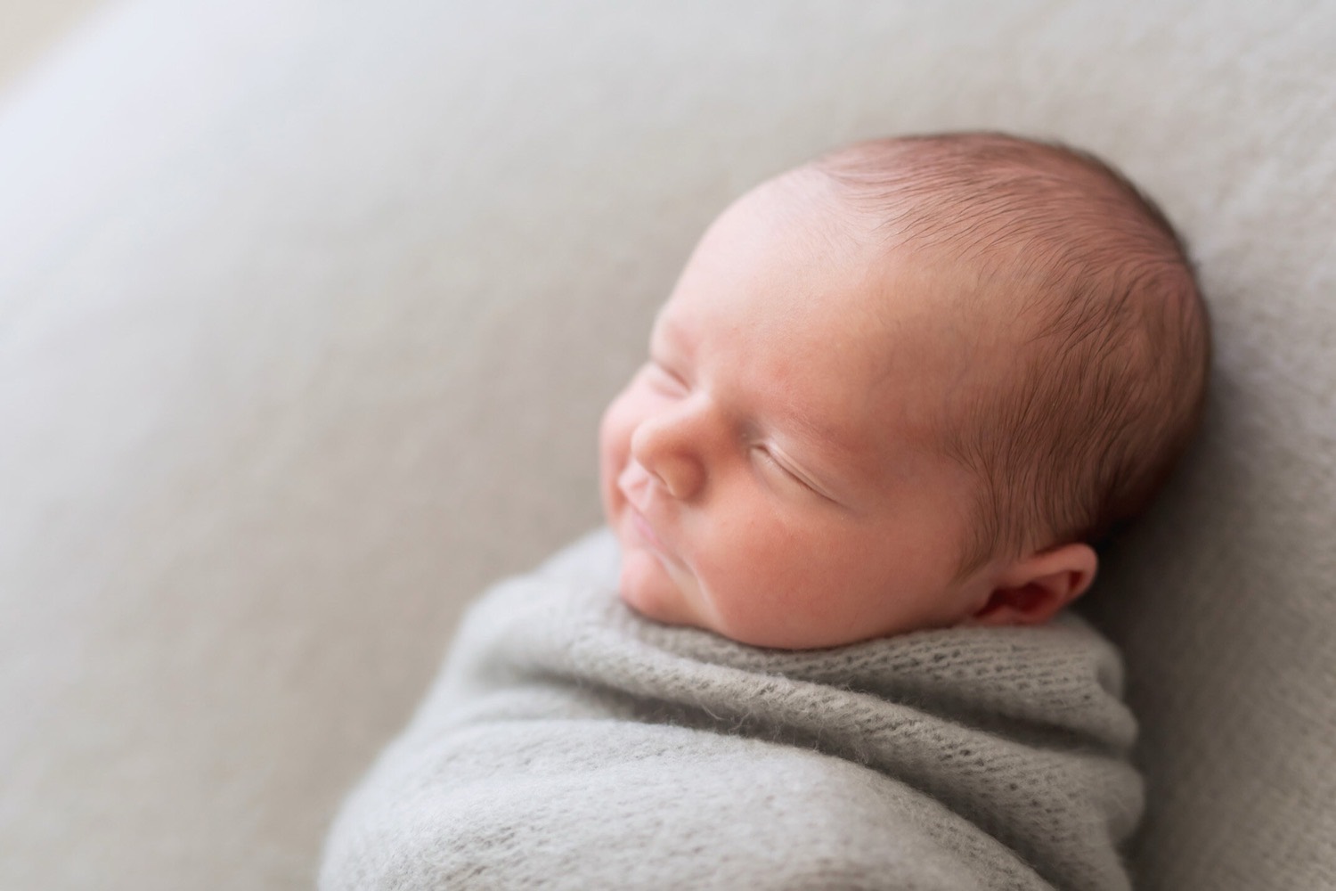 A newborn posed and wrapped in the Fresh Light studio